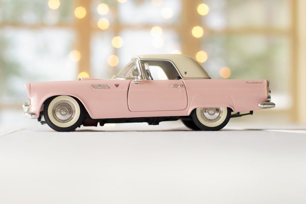 a pink car with a black rim