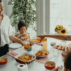 a woman and a child at a table with food