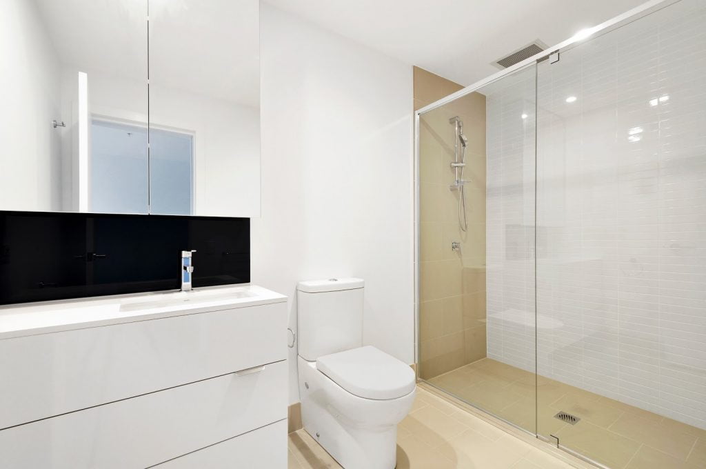 a bathroom with a shower and toilet