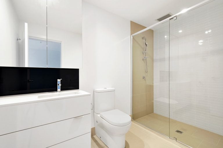 a bathroom with a shower and toilet