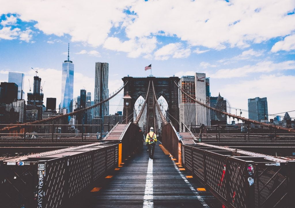 a bridge with a bridge and a city in the background