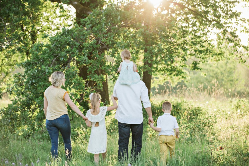 a group of people walking in a forest