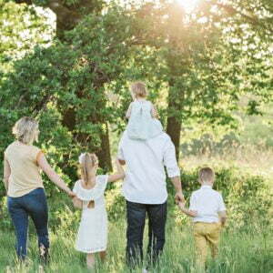 a group of people walking in a forest