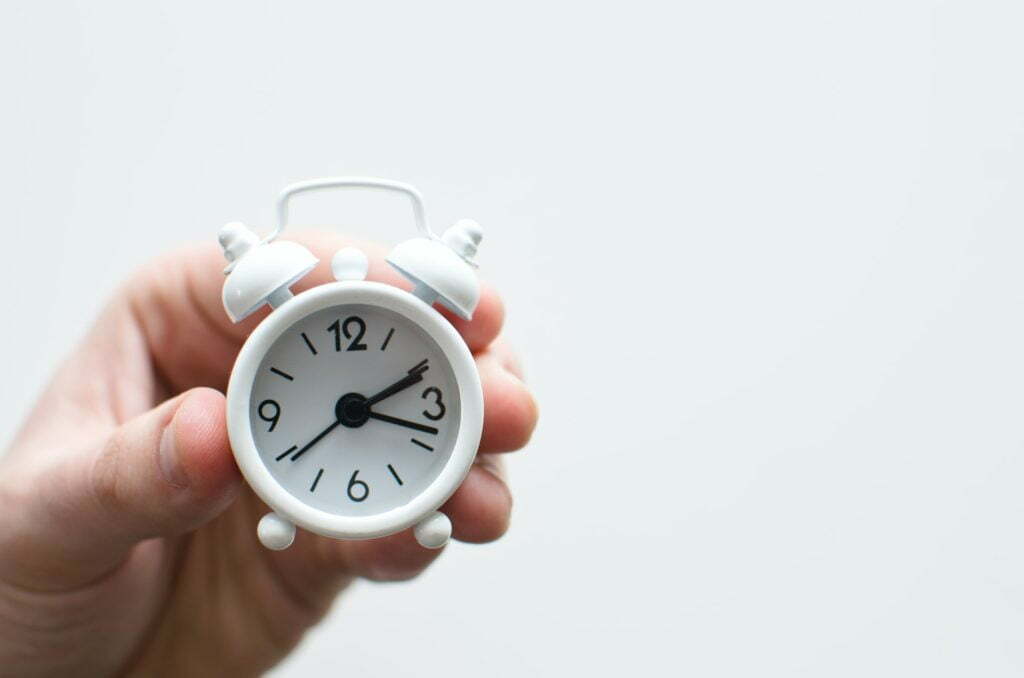 a hand holding a stopwatch
