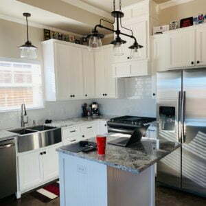 a kitchen with white cabinets