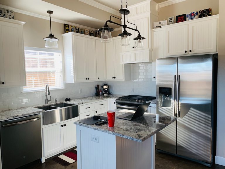 a kitchen with white cabinets
