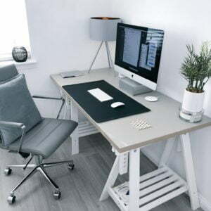 a desk with a computer and a chair