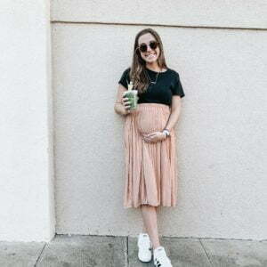 a woman holding a green cup