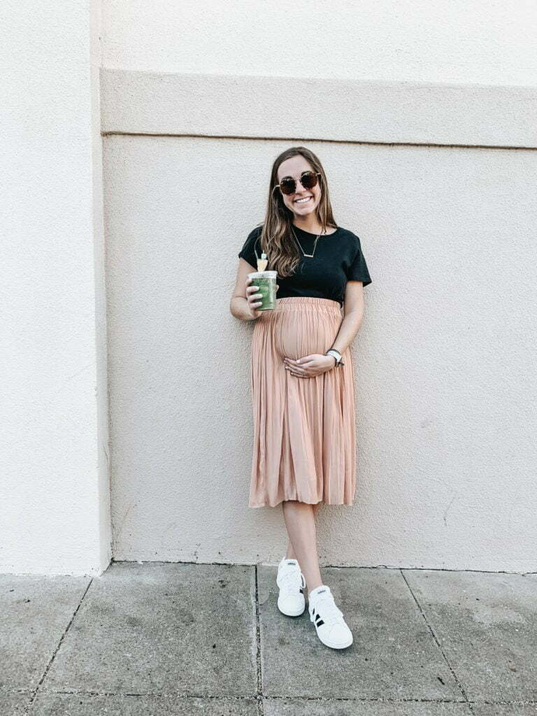 a woman holding a green cup
