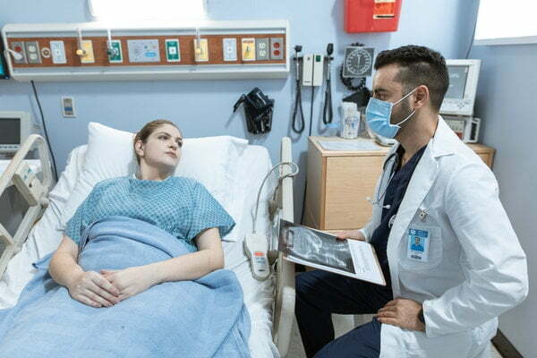 a doctor checking a patient's blood pressure