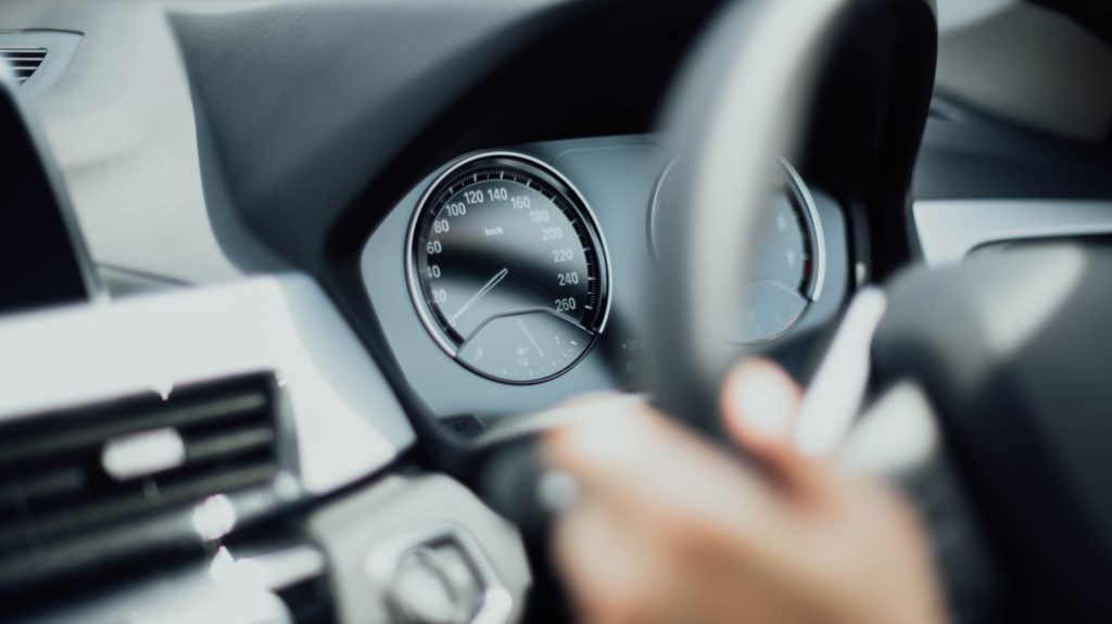 a person holding a steering wheel