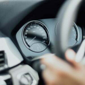 a person holding a steering wheel