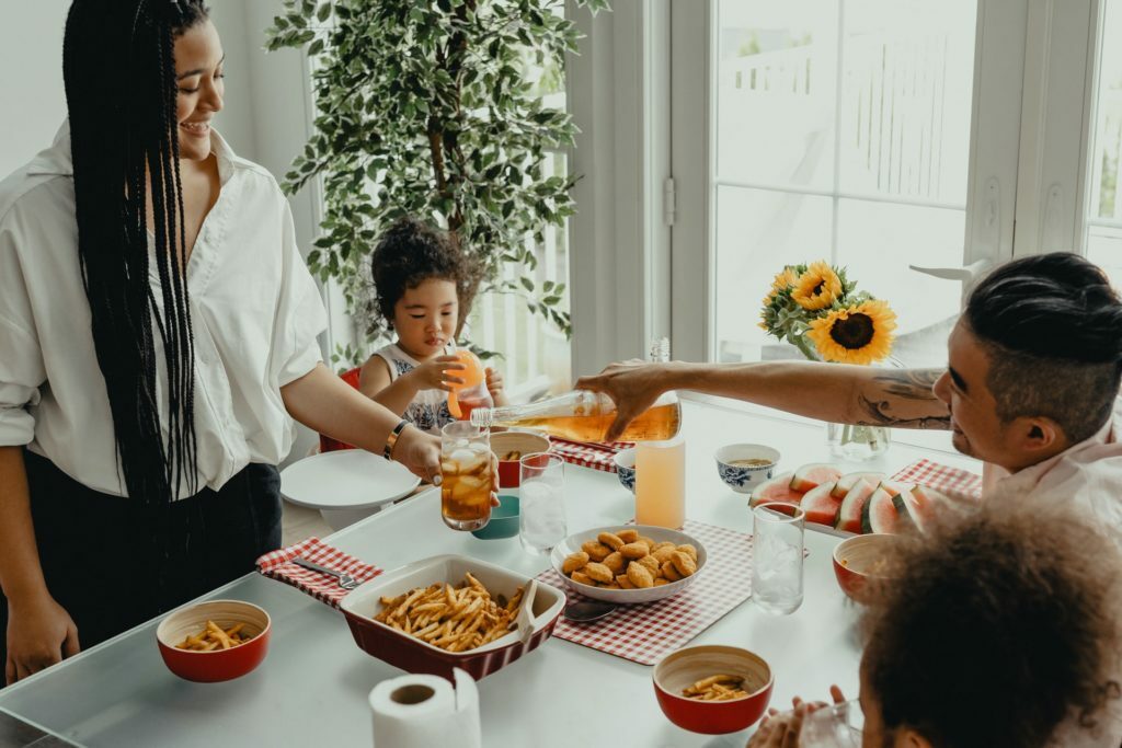 a woman and a child at a table with food