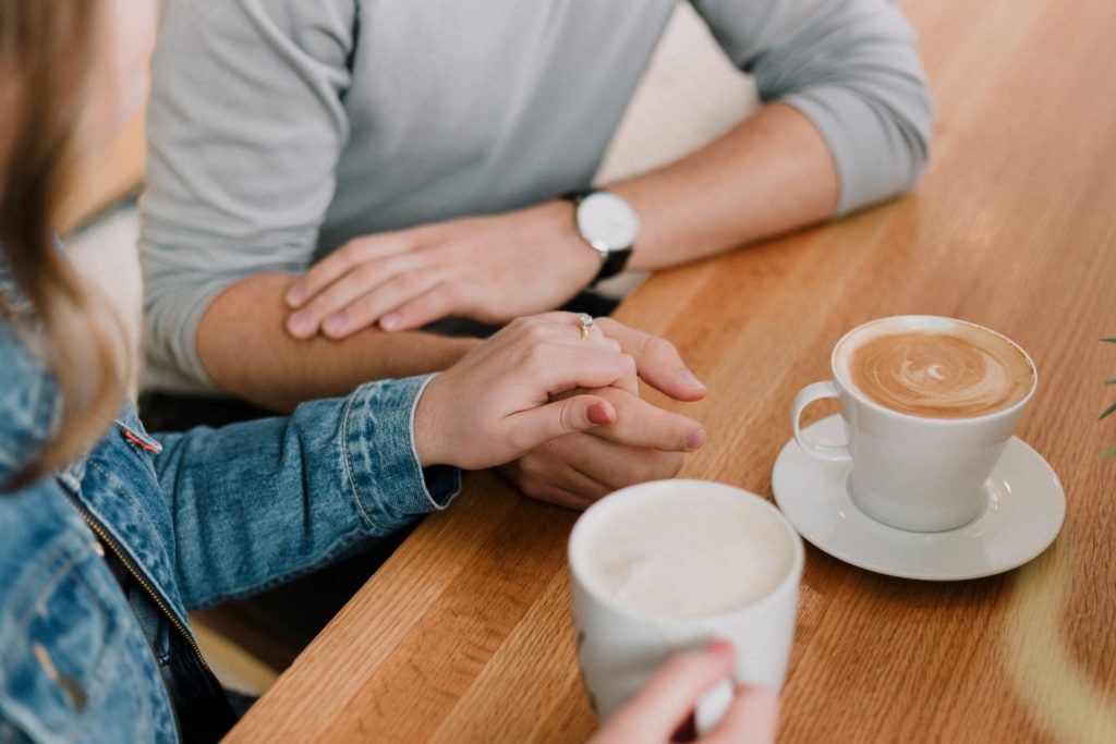 a person holding a cup of coffee