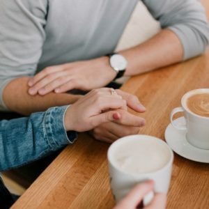 a person holding a cup of coffee