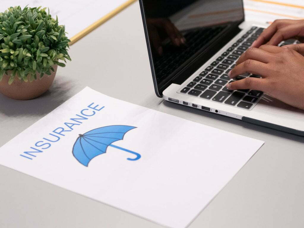 a hand holding a laptop