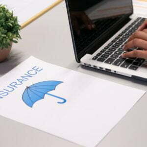 a hand holding a laptop